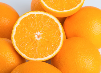 Fresh orange and cut in half on white background