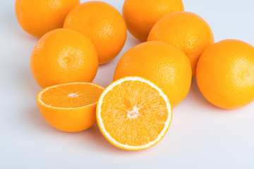 Fresh orange and cut in half on white background