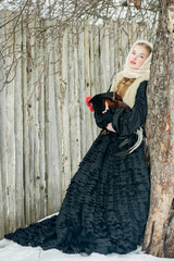 Fototapeta premium Beautiful Russian woman in a traditional dress. Russian village.