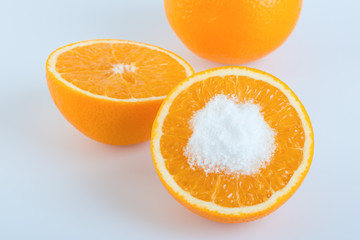 Orange fruit round slice with salt on white background