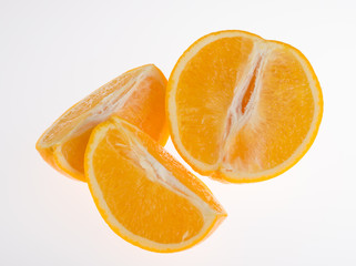 Fresh orange and cut in half on white background