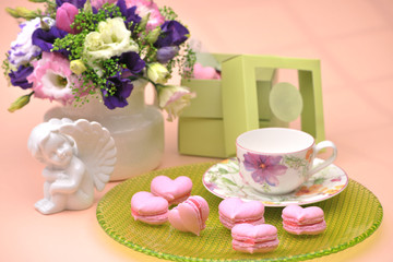 Fototapeta na wymiar pink cookies in the shape of hearts on a plate with angels and flowers on Valentine's Day