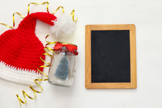 knitted santa hat and mason jar with christmas tree