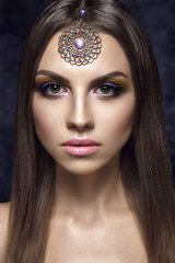 Beautiful woman portrait in east style with jewelry on forehead.