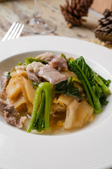 Fried noodle with pork and kale soaked in gravy