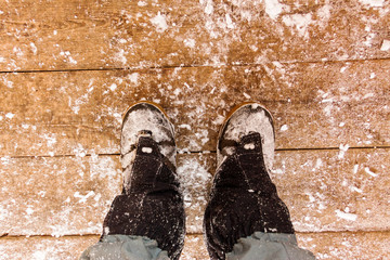 Top view of feet in boots and gaiters snow protection in the sno