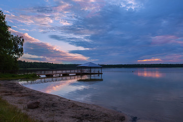 Fototapeta premium Wooded bridge in the lake between sunrise.