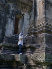 Fototapeta na wymiar Caretaker cleaning at Phimai historical park. Prasat Hin Phimai