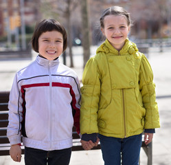 two children posing outdoors in the spring