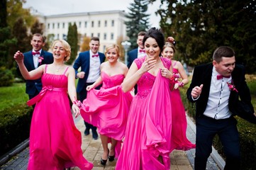 Four groomsmen and four bridesmaids having fun, stylish friends at wedding