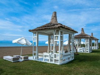 Beach huts and umbrellas.