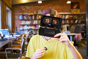 Female at the office play the fool with VR glasses