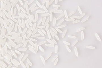 White jasmine rice close-up on white background. Decorative ending of rice.