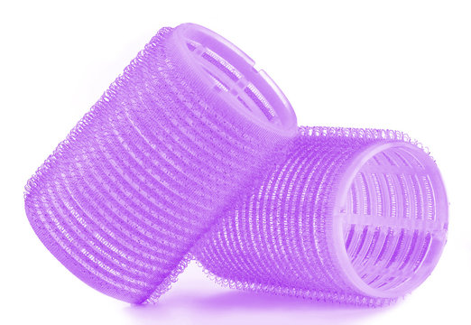 Set of two purple hair curlers isolated on white background