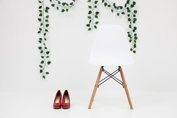 white chair with red shoes on a white background