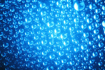 Blue water drops of on treat water-repellent surface in macro lens shot small-DOF for screen...