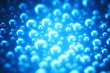 Blue water drops of on treat water-repellent surface in macro lens shot small-DOF for screen...