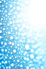 Blue water drops of on treat water-repellent surface in macro lens shot small-DOF for screen...
