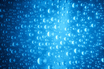 Blue water drops of on treat water-repellent surface in macro lens shot small-DOF for screen wallpapers