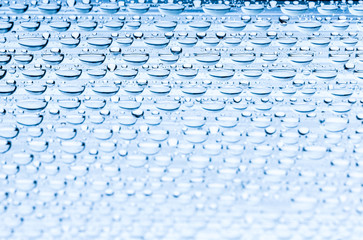Blue water drops of on treat water-repellent surface in macro lens shot small-DOF for screen...