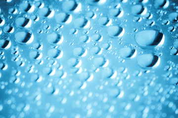 Blue water drops of on treat water-repellent surface in macro lens shot small-DOF for screen wallpapers