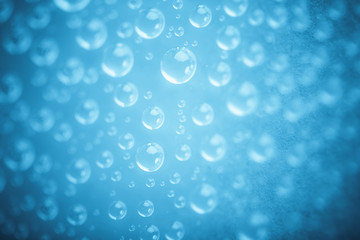 Blue water drops of on treat water-repellent surface in macro lens shot small-DOF for screen wallpapers
