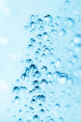 Blue water drops of on treat water-repellent surface in macro lens shot small-DOF for screen...