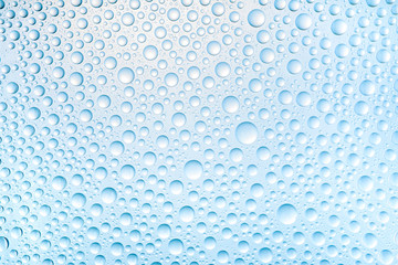 Blue water drops of on treat water-repellent surface in macro lens shot small-DOF for screen...
