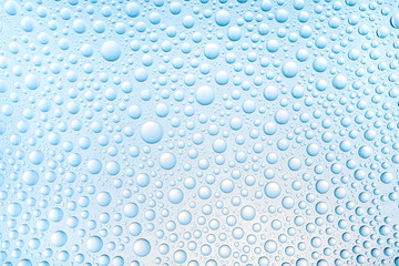 Blue water drops of on treat water-repellent surface in macro lens shot small-DOF for screen wallpapers