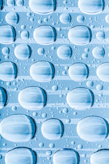 Blue water drops of on treat water-repellent surface in macro lens shot small-DOF for screen...