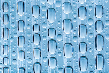Blue water drops of on treat water-repellent surface in macro lens shot small-DOF for screen wallpapers