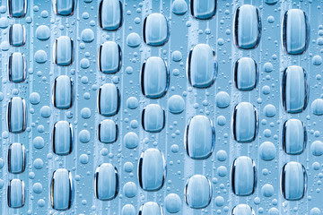 Blue water drops of on treat water-repellent surface in macro lens shot small-DOF for screen wallpapers