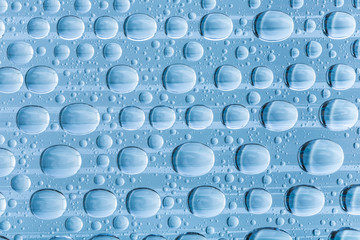 Blue water drops of on treat water-repellent surface in macro lens shot small-DOF for screen...