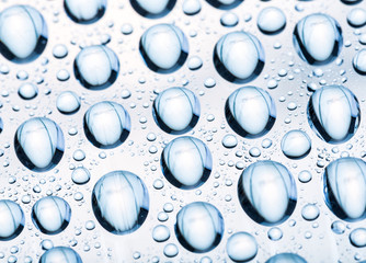 Blue water drops of on treat water-repellent surface in macro lens shot small-DOF for screen...