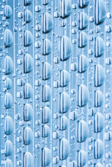 Blue water drops of on treat water-repellent surface in macro lens shot small-DOF for screen...