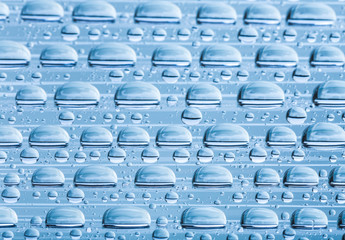 Blue water drops of on treat water-repellent surface in macro lens shot small-DOF for screen...