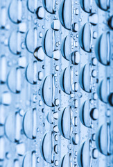 Blue water drops of on treat water-repellent surface in macro lens shot small-DOF for screen wallpapers