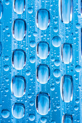 Blue water drops of on treat water-repellent surface in macro lens shot small-DOF for screen...