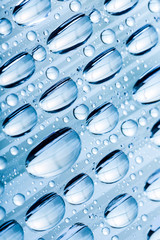 Blue water drops of on treat water-repellent surface in macro lens shot small-DOF for screen wallpapers