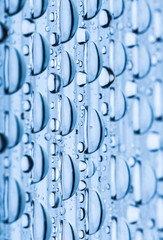 Blue water drops of on treat water-repellent surface in macro lens shot small-DOF for screen wallpapers