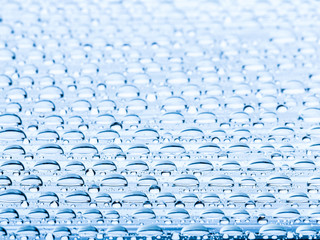 Obraz premium Blue water drops of on treat water-repellent surface in macro lens shot small-DOF for screen wallpapers