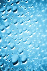 Blue water drops of on treat water-repellent surface in macro lens shot small-DOF for screen wallpapers