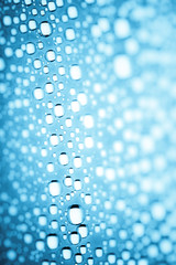 Blue water drops of on treat water-repellent surface in macro lens shot small-DOF for screen wallpapers