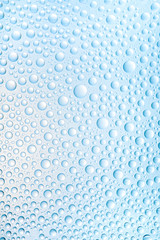 Blue water drops of on treat water-repellent surface in macro lens shot small-DOF for screen wallpapers