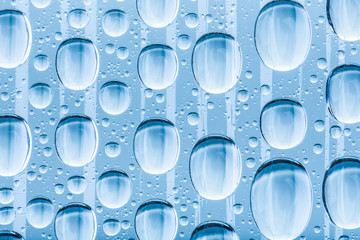 Blue water drops of on treat water-repellent surface in macro lens shot small-DOF for screen...