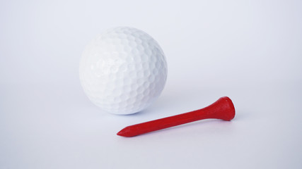 golf ball and red wooden golf tees on white background, sport time
