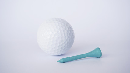 golf ball and light blue wooden golf tees on white background, sport time