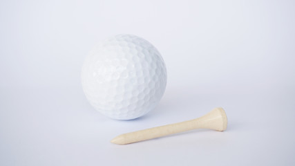 golf ball and soft yellow wooden golf tees on white background, sport time	