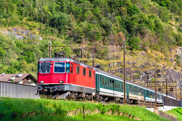 Naklejka premium Passenger train is climbing up the Gotthard pass - Switzerland