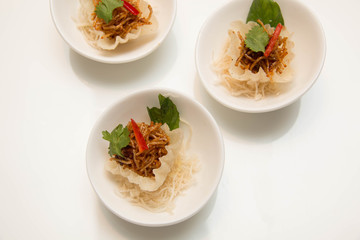  thai  appetizer presented on  small cup and garnish.